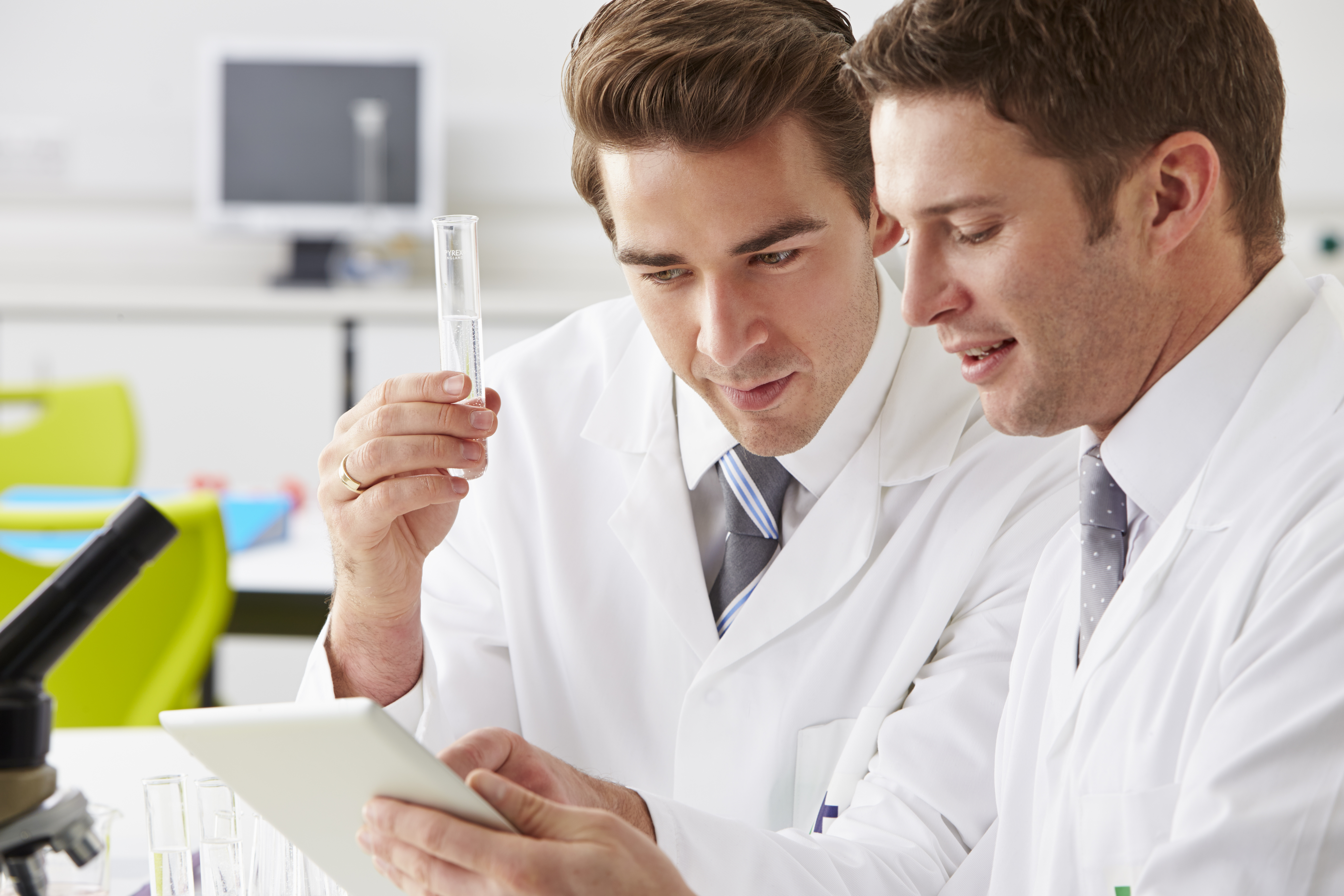 Two Technicians Working In Laboratory